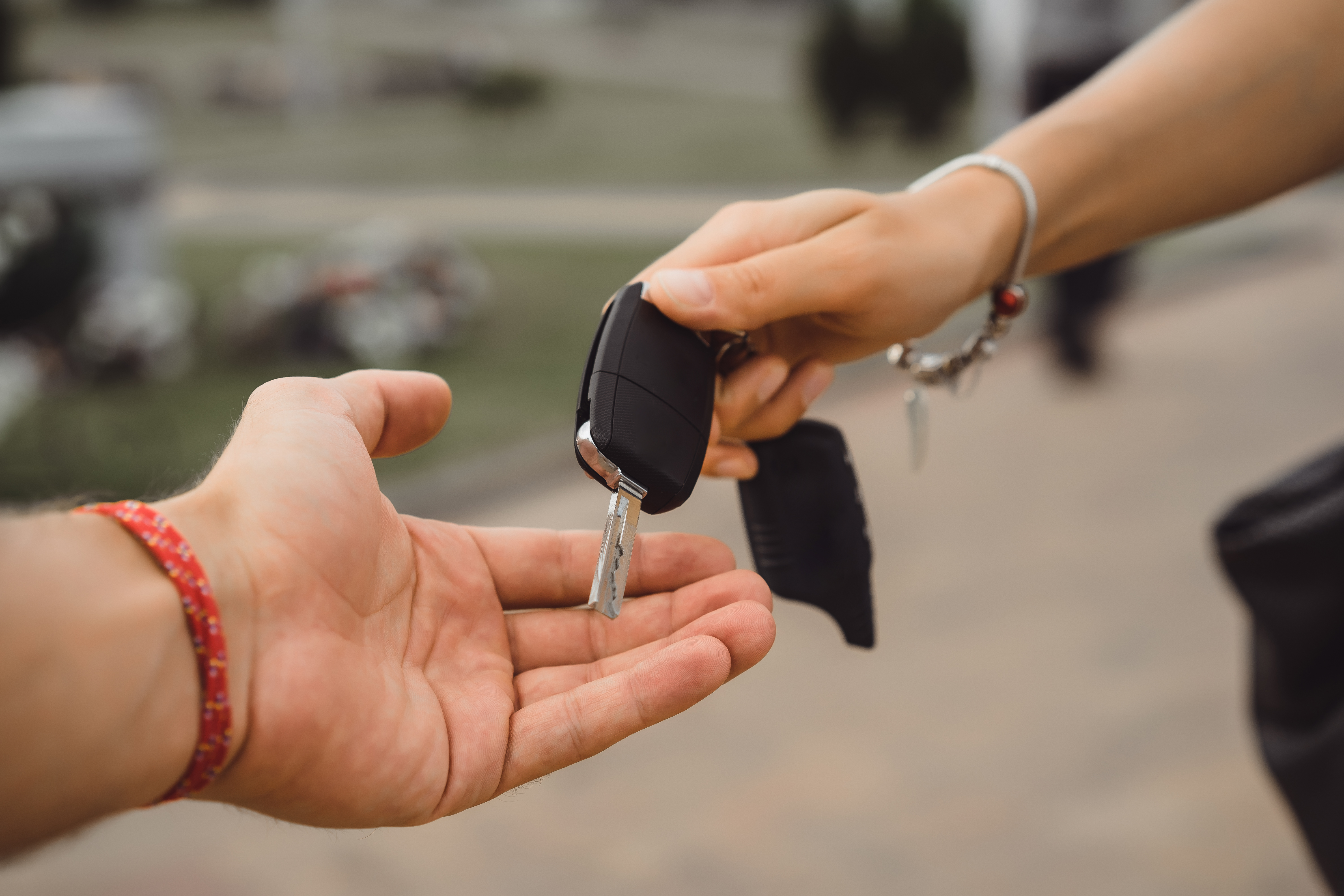 Woman Handing Car Keys to Locksmith 