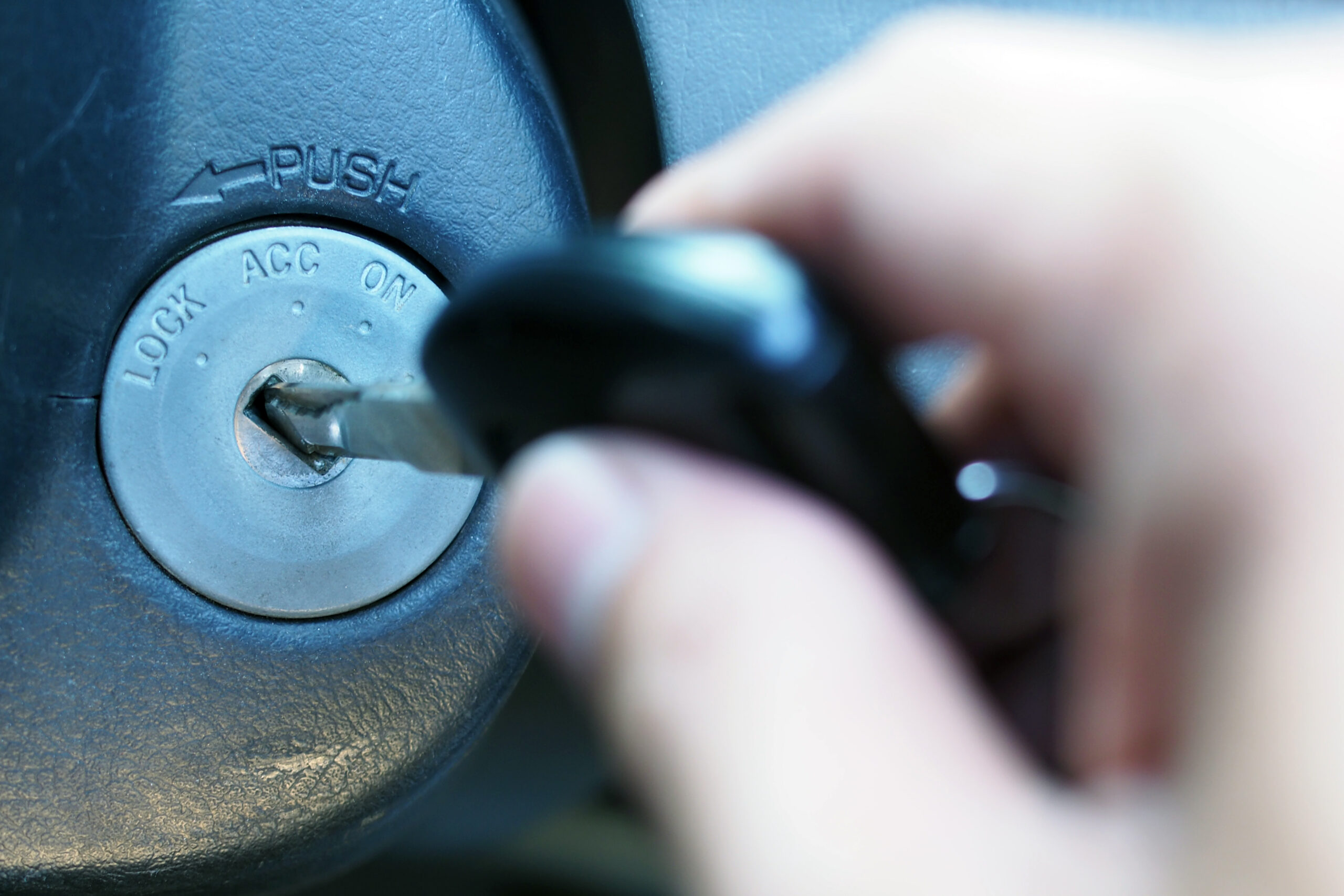 Hand Inserting Car Key Into Car Ignition